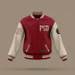 A varsity-style bomber jacket mockup floating against a solid taupe background. The jacket features a deep red body with cream-colored sleeves, red and cream striped ribbed collar, cuffs, and hem, and white gothic lettering on the chest reading 'PSD' alongside a red number '2' on the right sleeve.