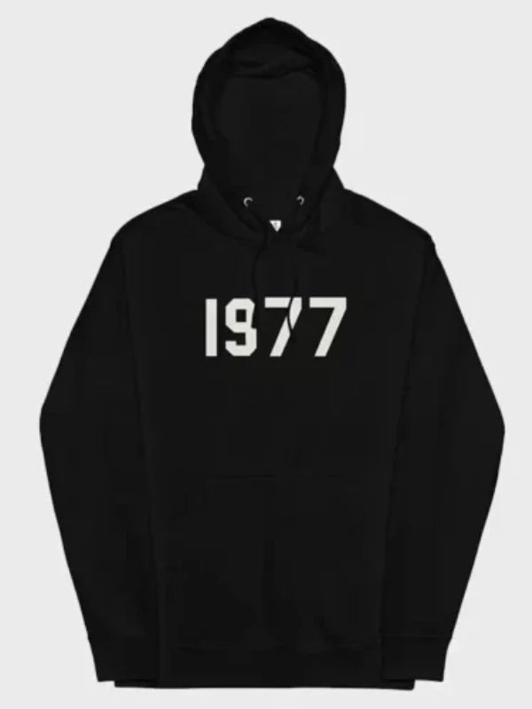 This classic black 1977 Essentials Hoodie displays the prominent white graphic numbers across the chest for a clean, timeless look.