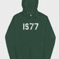 This green 1977 Essentials Hoodie features the bold white number graphic centered on the chest, creating a strong, recognizable streetwear look.