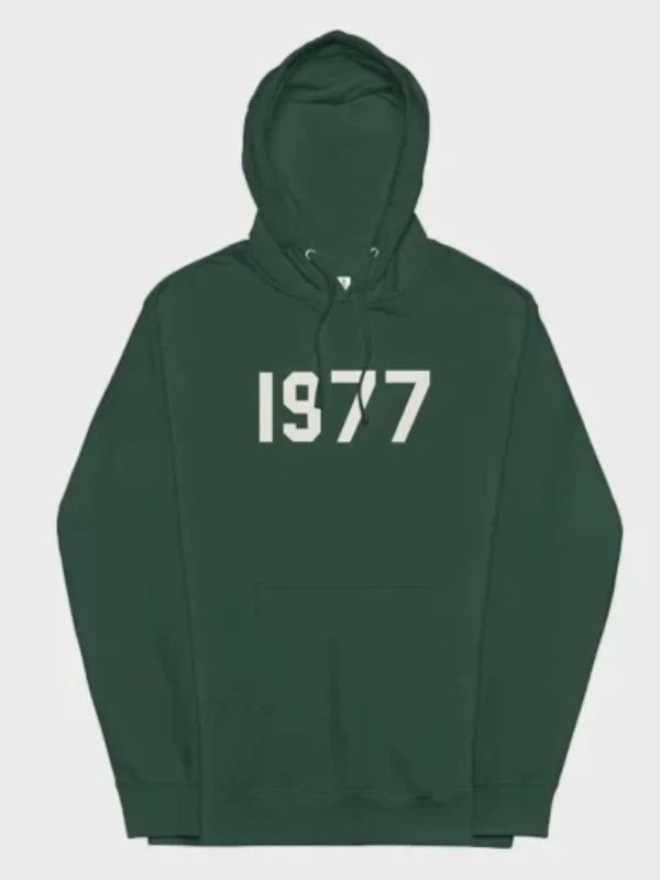 This green 1977 Essentials Hoodie features the bold white number graphic centered on the chest, creating a strong, recognizable streetwear look.
