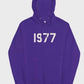 This vibrant purple 1977 Essentials Hoodie displays the prominent white numerical design, offering a unique and authentic collector's aesthetic.