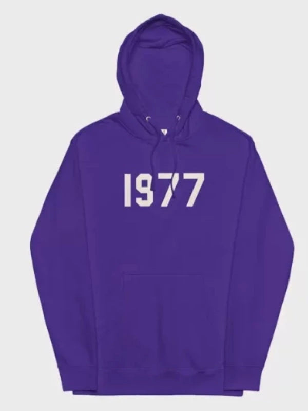 This vibrant purple 1977 Essentials Hoodie displays the prominent white numerical design, offering a unique and authentic collector's aesthetic.