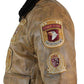 Brown leather jacket with patches on a white background