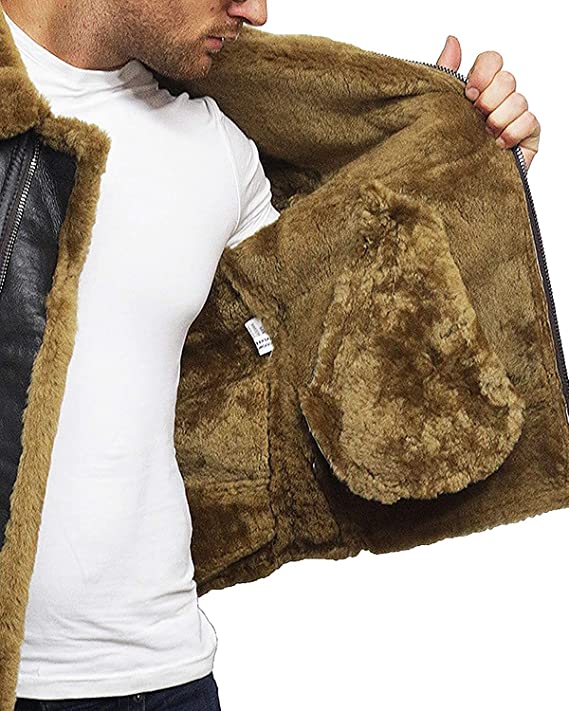 Brown shearling jacket with leather accents being held open by a person wearing a white shirt.
