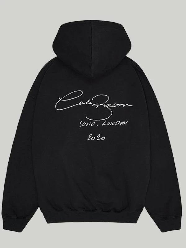Back view of the Black Cole Buxton Oversized Hoodie, clearly showing the large, white signature script graphic with the Soho, London 2020 detail.