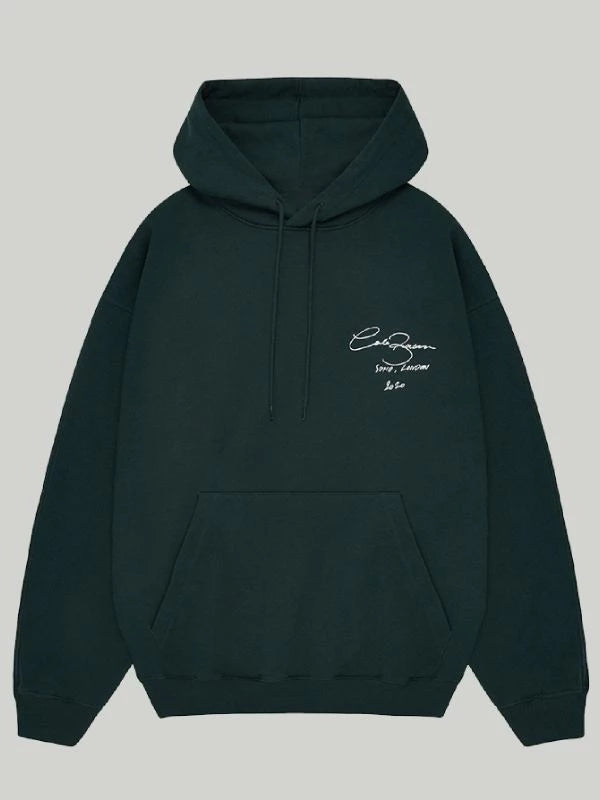 Front view of the Deep Forest Green Cole Buxton Oversized Hoodie, showcasing the crisp white signature script logo on the chest, signifying quality and minimalist style.