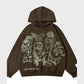 Front view of the brown streetwear hoodie, displaying the prominent luminous-white line-art characters and unique text graphic across the garment face.