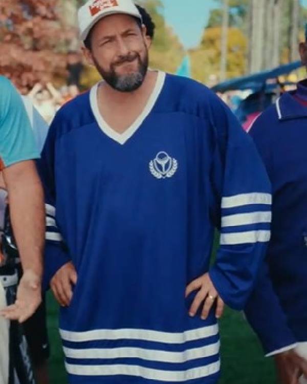 Man wearing a Happy Gilmore 2 Adam Sandler Blue Jersey with a logo, standing outdoors.