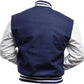 Navy blue varsity jacket with white sleeves on a white background