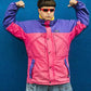 Person wearing a colorful jacket with a blue background