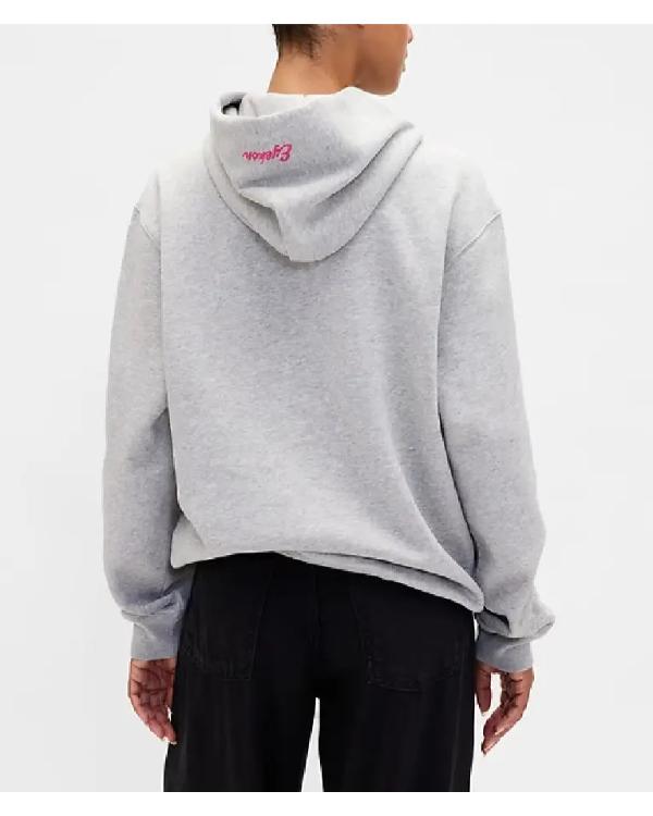 Person wearing a gray hoodie with a logo on the back against a white background