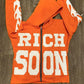 Front view of Orange Rich-Soon-Zip-Up-Hoodie