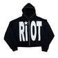 Black hoodie with 'Riot' text and star design on a white background