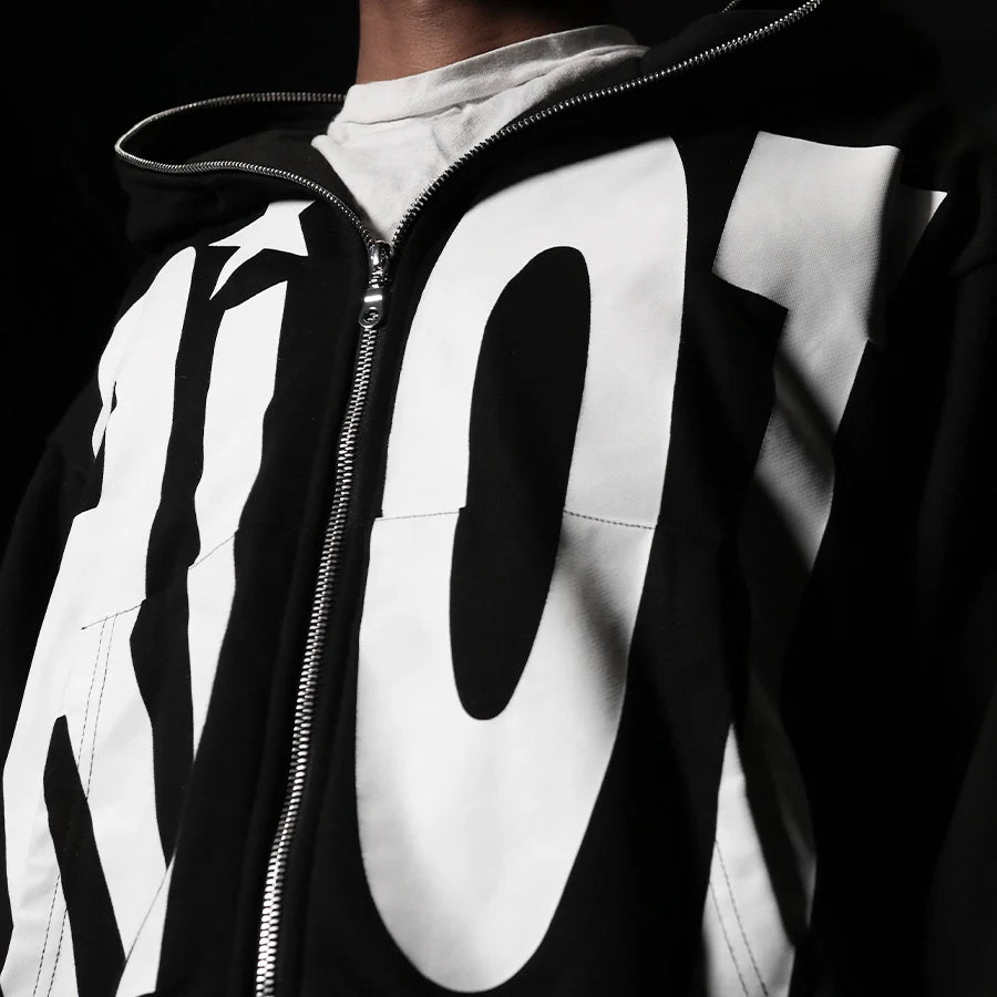 Black and white jacket with large lettering on a dark background