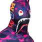 Close-up detail of the shark face graphic on the hood of a violet, pink, and navy camouflage zip-up hoodie.