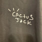 Text 'Cactus Jack' written on a black hoodie