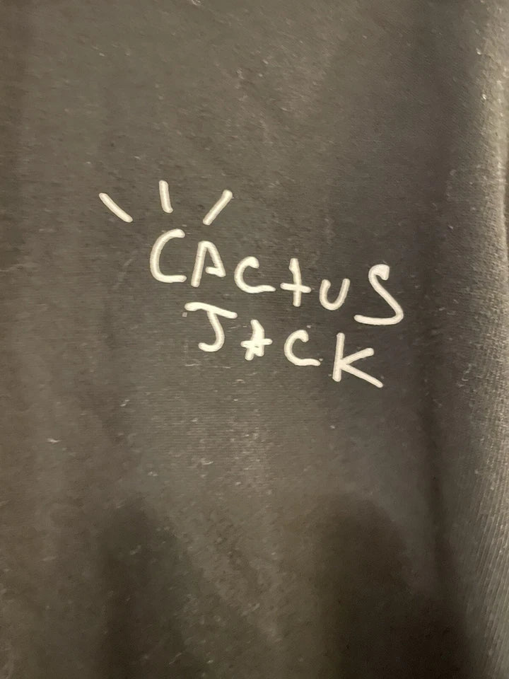 Text 'Cactus Jack' written on a black hoodie