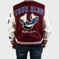 Person wearing a maroon and beige True Religion Letterman Jacket with 'True Rlgn' branding on the back.