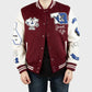 Man wearing a maroon and white True Religion Letterman Jacket with various patches on a plain background