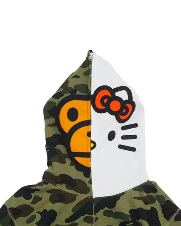 Close-up of BAPE Baby Milo and Hello Kitty split face on a full-zip 1st Camo hood.