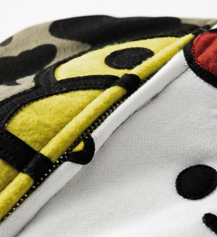 Close-up of BAPE Baby Milo hood interior and full-zip zipper pull detail.