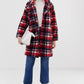 Styled front view of the Red, Navy, and White Plaid Bouclé Coat (Home For Christmas Ida Elise Broch Jacket). Perfect for a Merry Christmas!