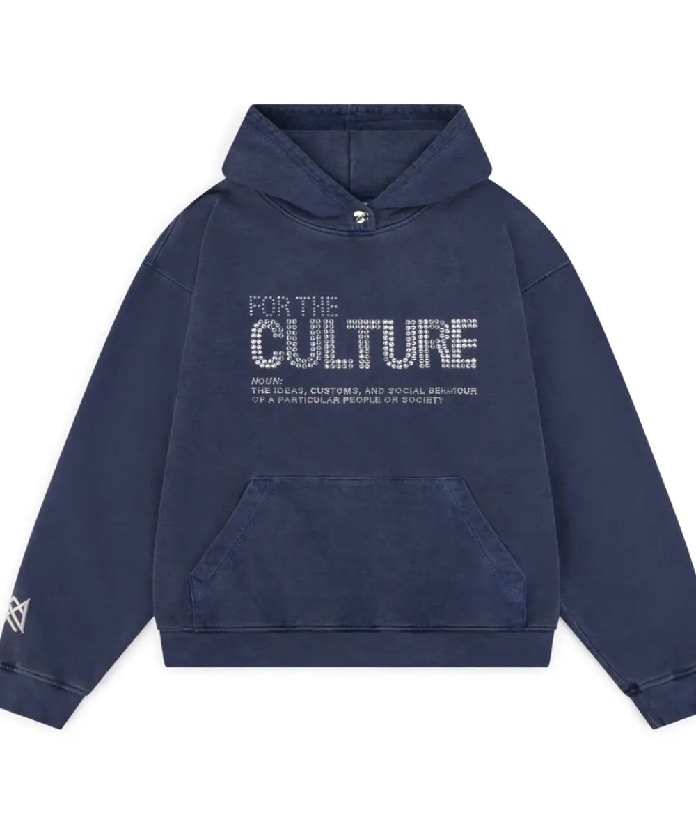 Oversized navy blue hoodie with "FOR THE CULTURE" text on the chest in silver crystal or rhinestone detail. Features a washed vintage look and a front pouch pocket.
