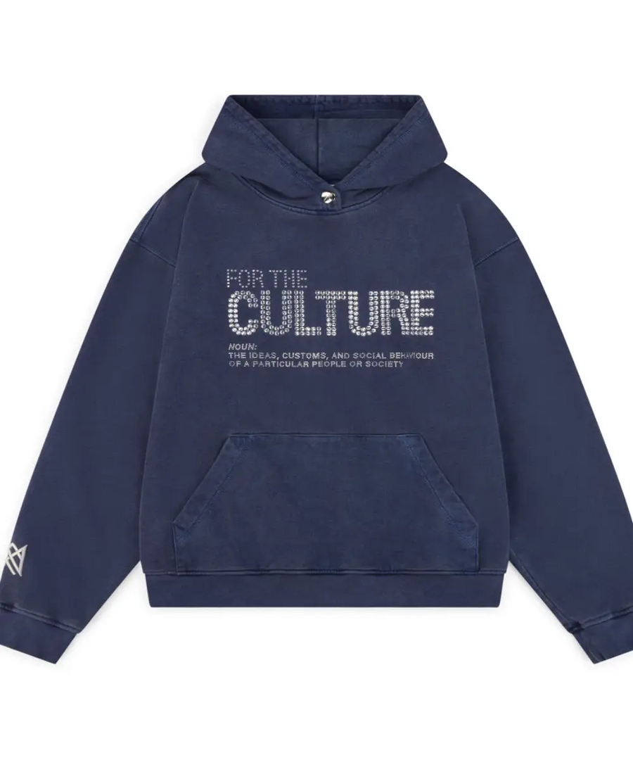 Oversized navy blue hoodie with "FOR THE CULTURE" text on the chest in silver crystal or rhinestone detail. Features a washed vintage look and a front pouch pocket.